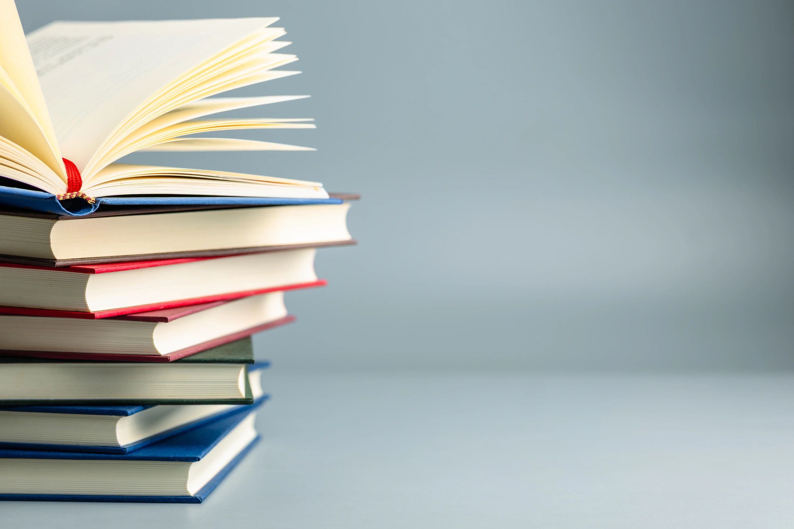 Open book on a stack of books